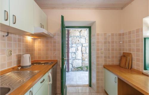 a kitchen with a sink and a window at Two-Bedroom Holiday Home In Tucepi in Tučepi