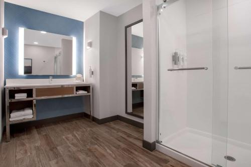 a bathroom with a shower and a sink at Hilton Garden Inn Omaha West in Omaha