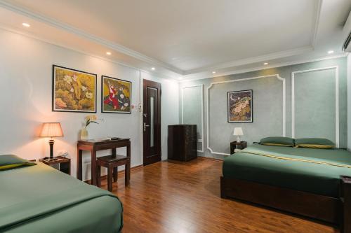 a hotel room with two beds and a desk at Villaxe Legume, 50m to Hoan Kiem lake - by Antique in Hanoi