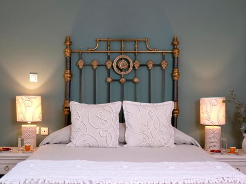 a bedroom with a large bed with two lamps at Mythos Suites Boutique Hotel in Rethymno