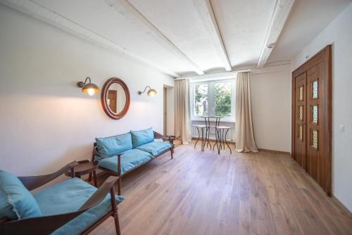 a living room with a couch and a table at Au Major Davel in Cully