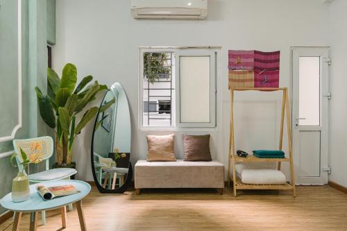 a living room with a couch and a mirror at Villaxe Legume, 50m to Hoan Kiem lake - by Antique in Hanoi