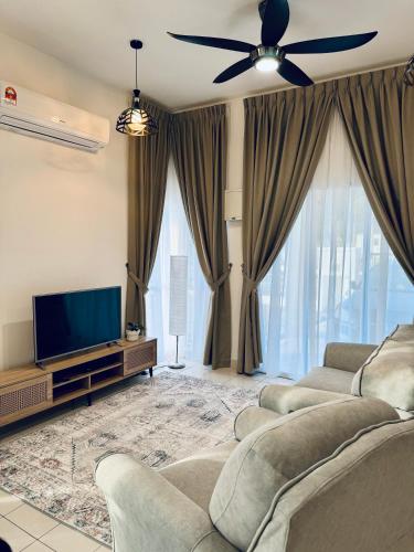 a living room with two couches and a flat screen tv at Rimbayu 81 in Kampung Bota Kiri