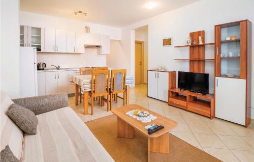 Una sala de estar con un sofá y una mesa y una cocina. en Holiday Home Crni Vi, en Drenje