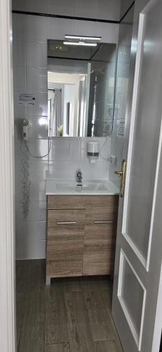 a bathroom with a sink and a mirror at Candisol Cozy Inns in Torremolinos