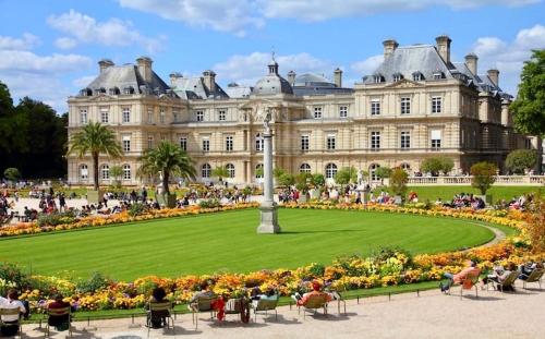 un grand bâtiment avec une pelouse verte devant lui dans l'établissement Studio entièrement rénové au cœur de Paris, à Paris