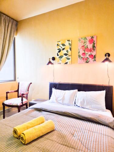 a bedroom with a bed with a yellow towel on it at Mossy Forest Family Retreat III, 2-8pax, Sunrise View, Cameron Highlands in Cameron Highlands