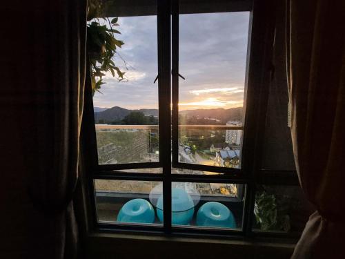 a window with a view of a view of a field at Mossy Forest Family Retreat III, 2-8pax, Sunrise View, Cameron Highlands in Cameron Highlands