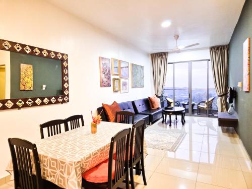 a living room with a table and a couch at Mossy Forest Family Retreat III, 2-8pax, Sunrise View, Cameron Highlands in Cameron Highlands