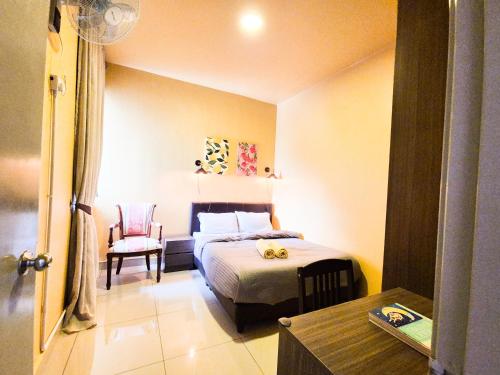 a small bedroom with a bed and a chair at Mossy Forest Family Retreat III, 2-8pax, Sunrise View, Cameron Highlands in Cameron Highlands