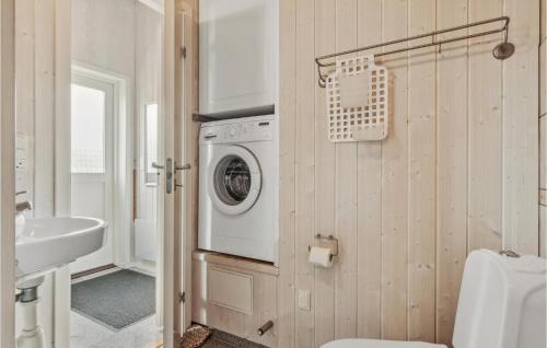 a bathroom with a washing machine and a sink at Holiday Home Løjtnantvænget Rudkøbing V in Spodsbjerg