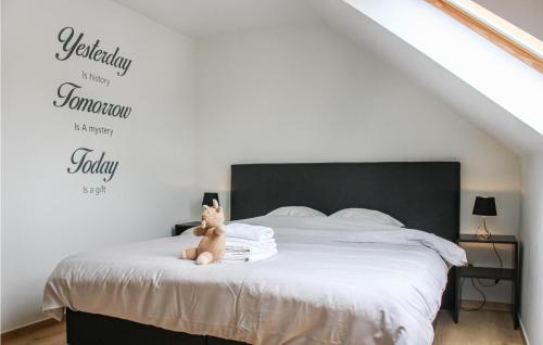 a cat sitting on a bed in a bedroom at Awesome Home In Diksmuide in Diksmuide