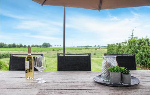 a bottle of wine and a glass on a wooden table at Awesome Home In Diksmuide in Diksmuide