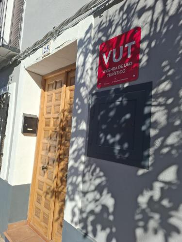 a sign on the side of a building with a door at Casa Luisa - Casa Completa con Encanto Valdepeñas in Valdepeñas