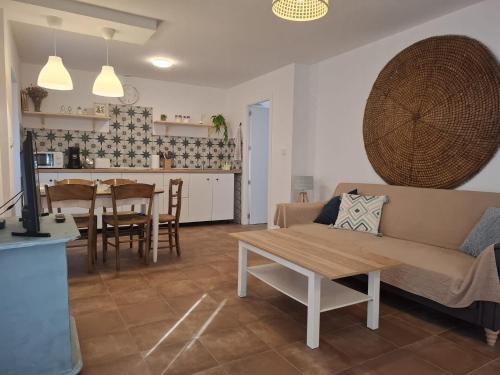 a living room with a couch and a table at Casa Luisa - Casa Completa con Encanto Valdepeñas in Valdepeñas