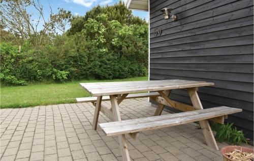 a wooden picnic table sitting on a brick patio at Beautiful Home In Vemb With Wifi in Thorsminde