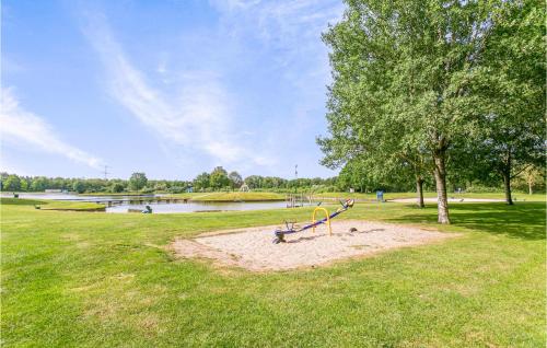 a playground in a park next to a lake at Nice Home In Hoge Hexel With Wifi in Hoge-Hexel