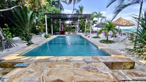 a swimming pool in the middle of a resort at Villa Bahati Zanzibar in Jambiani