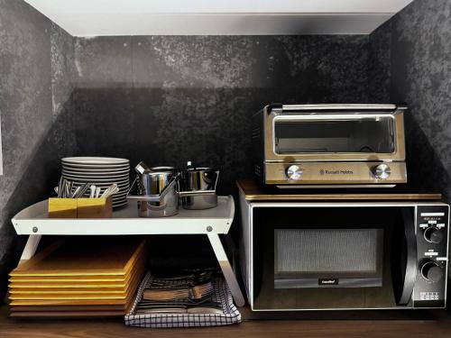 a kitchen with a toaster oven and a microwave at Kyoto ITOYA Hotel Mon in Kyoto