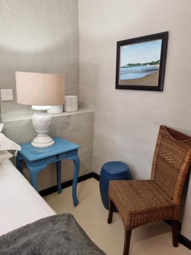 a bedroom with a bed and a table and a chair at Barrydale Karoo - BOUTIQUE HOTEL in Barrydale