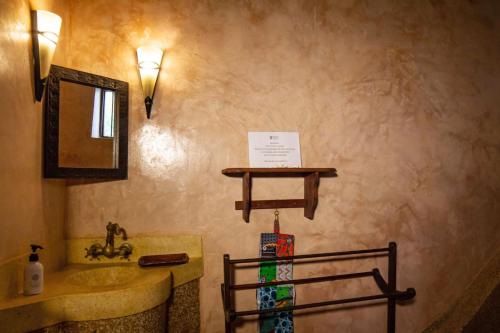 a bathroom with a sink and a mirror at Villa Bahati Zanzibar in Jambiani