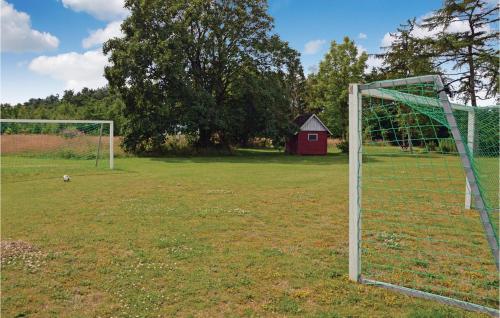 a soccer goal in a field with a red barn at Holiday Home Stakroge - 09 in Knaplund