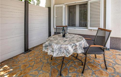a table and two chairs on a patio at 1 Bedroom Nice Home In Rogotin in Rogotin