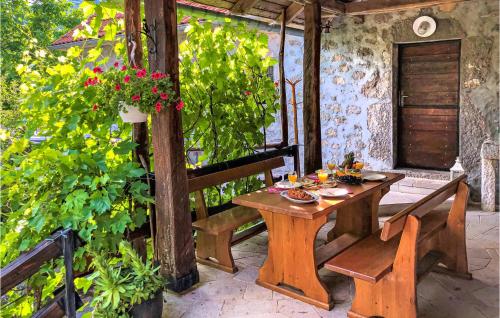 a wooden table and chairs on a patio at Amazing Home In Novi Vinodolski in Novi Vinodolski