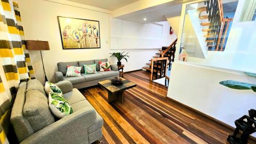 a living room with a couch and a table at 87 Guesthouse in Baguio