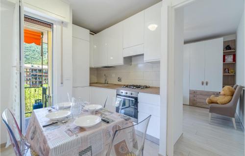 a kitchen and dining room with a table and chairs at Stunning Apartment In Recco With Wifi in Recco