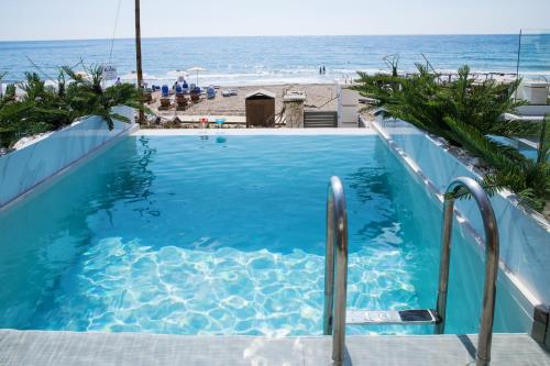 a swimming pool with a view of the beach at Agios Gordios Beach Resort in Agios Gordios