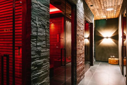 a bathroom with red shutters on the walls at SEVERIN*S – The Alpine Retreat in Lech am Arlberg