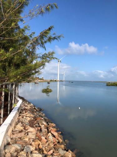 a view of a wind turbine in the water at Pousada Maré Cheia in Itarema
