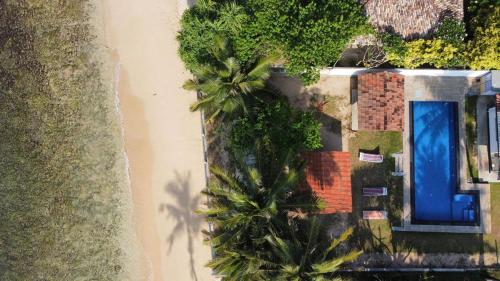 an overhead view of a house with palm trees at Avin Beach Villa in Unawatuna