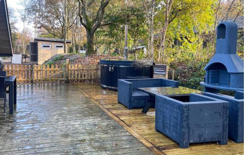 a patio with blue benches and a trash can at Three-Bedroom Holiday Home In Thyholm in Thyholm