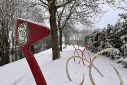 a red mailbox covered in snow in a park at Ô Jardin Secret in Oberschaeffolsheim
