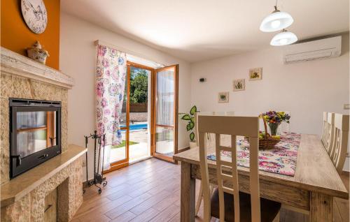 a kitchen and dining room with a fireplace and a table at Villa Ivka in Pula