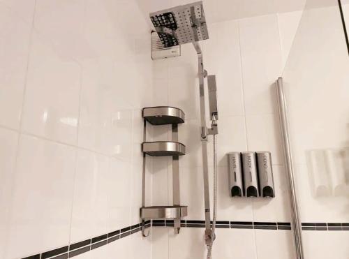 a shower in a white tiled bathroom at Lovely Serviced Apartment, Free Parking, Oxford in Oxford