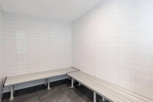 a empty waiting room with two benches in it at Luxury 2BR apartment in the heart of CBD in Adelaide