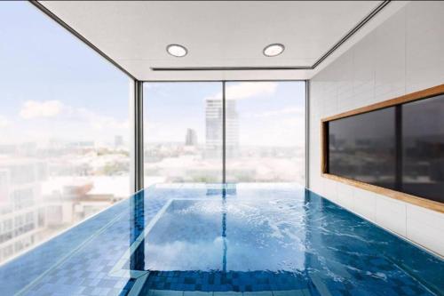 a swimming pool with a view of a building at Luxury 2BR apartment in the heart of CBD in Adelaide