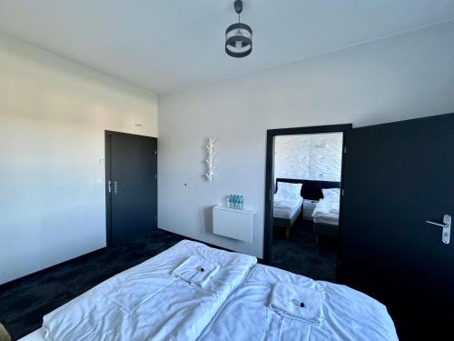 a bedroom with a large bed and a mirror at Hotel Leśny Korne koło Kościerzyny - Kaszuby in Korne