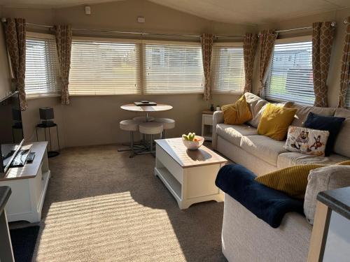 a living room with a couch and a table at J&D by the sea in Heysham