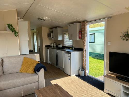 a living room with a couch and a kitchen at J&D by the sea in Heysham