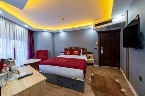 a hotel room with a bed and a flat screen tv at Viv City Hotel in Istanbul