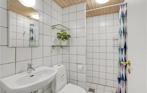 a white bathroom with a sink and a toilet at Pet Friendly Home In Vejers Strand in Vejers Strand