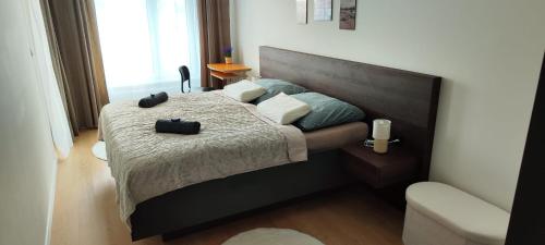 a bedroom with a bed with two bags on it at NEW apartment with free garage parking near the airport in Prievoz