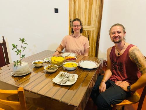 a man and woman sitting at a table with food at Millenium Lodge - Anuradhapura in Anuradhapura