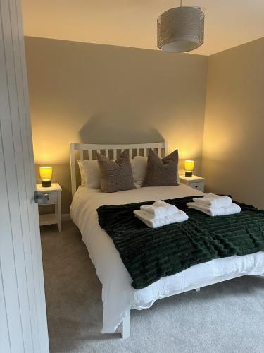 a bedroom with a large bed with two pillows at Castle View Apartments - The Hideout in Kendal