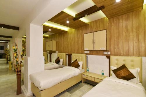 a room with four beds in a room at Hotel sallow International-Hotel Near Golden Temple in Amritsar