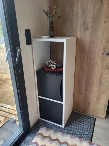 a small white cabinet with three drawers in a room at NATIBOXflo in Saint-Michel-de-Chavaignes